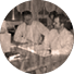 Two men sitting at a table with a book in front of them.

Description generated by AI